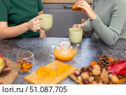 Two girls are drinking delicious tea and helping themselves to a pie. Стоковое фото, фотограф Alexandra Aleroewa / Фотобанк Лори