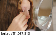 Teen Girl putting on makeup looking at mirror. Beautiful Teenager caring her face. 14 years old female applied cosmetics. Natural beauty concept. Skin care, make-up. Daily make up. Beautiful Teenage. Стоковое видео, видеограф Марина Демидюк / Фотобанк Лори