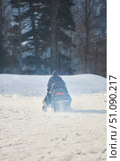 Transport snowmobile with driver on the background of white snow and high mountains. Winter travel in mountainous and forested areas. Стоковое фото, фотограф Наталия Кирсанова / Фотобанк Лори