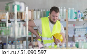 Young man builder with back pain at pharmacy. Стоковое видео, видеограф Яков Филимонов / Фотобанк Лори