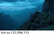 Mysterious dark castle in a fantasy landscape surrounded by mountainous terrain. Стоковое AI-изображение, AI-художник Ксения Лаптева / Фотобанк Лори