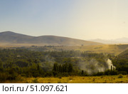 Forest fires smoke over the trees smoke on a background of trees and mountains. Стоковое фото, фотограф Feruza Tashmetova / Фотобанк Лори