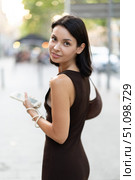 Slender female brunette with phone walks in vicinity of Passeig Nou in Barceloneta. Стоковое фото, фотограф Яков Филимонов / Фотобанк Лори