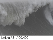 Turbulent dark waves surging, generating foamy spray amid stormy seascape, revealing oceanic raw power and elemental intensity. Стоковое фото, фотограф Данил Руденко / Фотобанк Лори