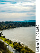 The fortress perched on Petrovaradin Hill watches over the city, while the charming streets and modern buildings of Novi Sad are spread out, creating a perfect blend of history and contemporary life. Стоковое фото, фотограф Feruza Tashmetova / Фотобанк Лори