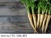 Bunch of fresh parsnips lying on rustic wooden table. Стоковое AI-изображение, AI-художник Иван Рябоконь / Фотобанк Лори