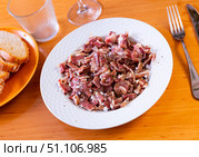 Pieces of pickled and boiled pork ears perfectly complement glass of dark beer. Стоковое фото, фотограф Яков Филимонов / Фотобанк Лори