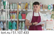 Disgruntled male salesman conducts an inspection of a hardware store. Стоковое видео, видеограф Яков Филимонов / Фотобанк Лори