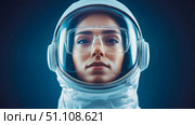 Close-up portrait of focused woman wearing futuristic astronaut helmet with clear visor and protective eyewear, symbolizing innovation in space exploration. Стоковое AI-изображение, AI-художник Данила Большаков / Фотобанк Лори