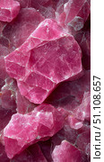 Close-up detailed view of numerous raw, fractured deep fuchsia pink mineral fragments showcasing their rugged texture and crystalline formations, creating vibrant abstract geological background. Стоковое AI-изображение, AI-художник Данила Большаков / Фотобанк Лори