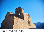 Stepantsminda, Georgia - January 03, 2023: Gergeti Church of the 14th century at the foot of Mount Kazbek. Редакционное фото, фотограф Наталия Кирсанова / Фотобанк Лори