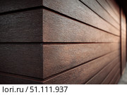 Modern brown wood plank texture. Fiber cement siding. Exterior of composite wall. Plastic material is eco-friendly polymer panels in rows. Wooden grain surface. Hollow WPC boards. Dark oak color. PE. Стоковое AI-изображение, AI-художник Марина Демидюк / Фотобанк Лори