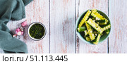A bowl of spicy lightly salted cucumbers with herbs on the table top view web banner. Стоковое фото, фотограф Елена Руй / Фотобанк Лори