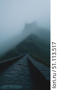 Misty pathway winding up a mountain in a serene and atmospheric setting at dawn. Стоковое AI-видео, аниматор Сергей Толмачёв / Фотобанк Лори