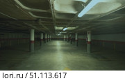 Well lit empty underground parking garage. Стоковое видео, видеограф Данил Руденко / Фотобанк Лори