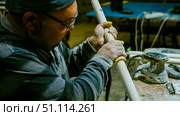 carpenter using nail gun or brad nailer tool on wood box in a workshop ,furniture restoration woodworking concept. selective focus. Стоковое фото, фотограф Feruza Tashmetova / Фотобанк Лори