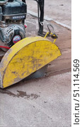 A yellow-black machine with yellow equipment attached to it. The machine is used for cutting asphalt. Редакционное видео, видеограф Ярославский Максим / Фотобанк Лори