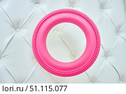 A pink frame sits on a white bedspread. Стоковое фото, фотограф Наталия Кирсанова / Фотобанк Лори