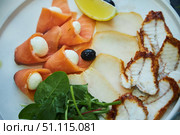 A plate of food with a variety of fish and vegetables. The plate is white and the food is arranged in a visually appealing manner. Стоковое фото, фотограф Наталия Кирсанова / Фотобанк Лори