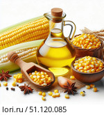 Corn cobs in a green husk, a glass bottle of golden butter and a small jar of butter are placed against the background of burlap. Grits and grains add a rustic style. Стоковое AI-изображение, AI-художник Светлана  Громак / Фотобанк Лори