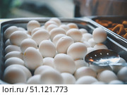 Piled high in a metal serving tray, white eggs await breakfast or brunch, complemented by a metal slotted spoon resting conveniently on top, ready for serving. Стоковое фото, фотограф Ольга Ильина / Фотобанк Лори