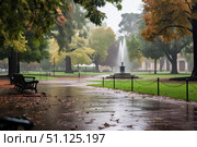 Rain falling on city park with fountain and benches in autumn. Стоковое AI-изображение, AI-художник Иван Рябоконь / Фотобанк Лори