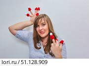 A woman with warm hats on each finger. An indecent hand gesture. The arrival of the cold season, insulation. Resistance to cold and winter season. Стоковое фото, фотограф Наталия Кирсанова / Фотобанк Лори