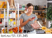 Young woman scanning qr code of raw pork. Стоковое фото, фотограф Яков Филимонов / Фотобанк Лори