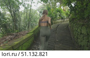 Slow motion follow-up Shot of Young Athlete Woman Running. Outdoor training in Bali. Стоковое видео, видеограф Степанов Григорий / Фотобанк Лори