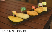 Pieces of different Durians on the counter at market. Exotic tropical fruit. Asian king of fruits. Стоковое видео, видеограф Степанов Григорий / Фотобанк Лори