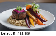Succulent filet mignon adorned with vibrant beetroot relish, plated alongside roasted quinoa and seasonal root vegetables, highlighting refined culinary expertise. Стоковое AI-видео, аниматор Юрий Поздников / Фотобанк Лори