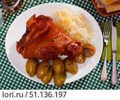 Oven baked pork knuckle with potatoes and cabbage on plate. Стоковое фото, фотограф Яков Филимонов / Фотобанк Лори