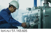 A technician works diligently on machinery, troubleshooting and repairing while steam rises in an industrial setting. Стоковое AI-видео, аниматор Данила Большаков / Фотобанк Лори
