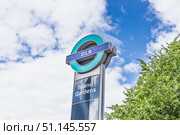 DLR Island Gardens station sign with TfL roundel. London, UK, 16 June 2024. Редакционное фото, фотограф Zydrius Tartenis / Фотобанк Лори