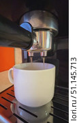 Espresso machine with white cup of coffee in the home kitchen background. Morning concept. Slow motion vertical footage. Стоковое видео, видеограф Ирина Михайличенко / Фотобанк Лори