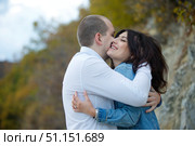 Young couple guy and girl, passionate embrace on the street. A loving couple. Feelings and emotions. Стоковое фото, фотограф Наталия Кирсанова / Фотобанк Лори