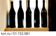 Bottles of wine on shelf in store. Стоковое AI-изображение, AI-художник Дмитрий Нечаев / Фотобанк Лори