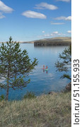 Baikal Lake in summer. Vertical video of two girls in orange life jackets and hats riding SUP boards on blue water of Small Sea on sunny day. Active seaside recreation. Стоковое видео, видеограф Виктория Катьянова / Фотобанк Лори