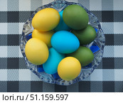Colorful Easter eggs lie in a glass vase. Yellow, blue, green, Golden eggs. Стоковое фото, фотограф Олег Тараканов / Фотобанк Лори
