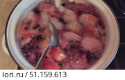 Close-up of apples boiling in a pot with water. The process of making homemade fruit compote from fresh apples. Boiling, bubbles on the surface, natural food and a cozy kitchen atmosphere. Стоковое видео, видеограф Андрей Жигальцов / Фотобанк Лори