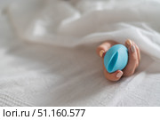 A faceless woman lies in bed under a blanket holding a clitoral vibrator. The girl masturbates. Стоковое фото, фотограф Михаил Решетников / Фотобанк Лори