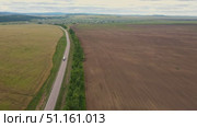 Agricultural landscape captured in aerial view near rural area. Стоковое видео, видеограф Гурьянов Андрей / Фотобанк Лори