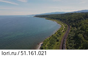 Scenic view of a tranquil shoreline along a vast lake with lush greenery. Стоковое видео, видеограф Гурьянов Андрей / Фотобанк Лори