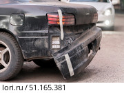 Insurance case - the bumper of the car was attached with masking tape. Unprofessional artisanal car repairs. The bumper fell off, a funny accident. Стоковое фото, фотограф Владимир Разгуляев / Фотобанк Лори