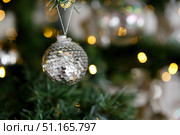 Christmas decoration ball of sequins on the background of branches and lights of garlands. Стоковое фото, фотограф Aleksandra Selivanova / Фотобанк Лори