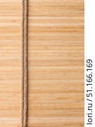Frame of two smooth ropes lying on a bamboo mat. Стоковое фото, фотограф Александр Собко / Фотобанк Лори
