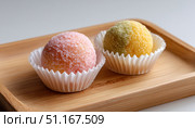 Colorful brigadeiros displaying traditional brazilian chocolate flavor, sitting in white paper cups atop rustic wooden surface, dusted with fine granulated sugar. Стоковое AI-изображение, AI-художник Юрий Поздников / Фотобанк Лори