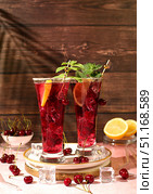 Sangria or cocktail with mint, cherry, soda, lemon and ice, a recipe for a refreshing summer and autumn drink, a detox diet and weight loss concept, a restaurant and bar menu. Cold homemade lemonade. Стоковое фото, фотограф Светлана Балынь / Фотобанк Лори