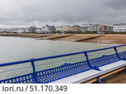 Eastbourne seafront from the pier with blue railings. Eastbourne, UK, 2 July 2024. Редакционное фото, фотограф Zydrius Tartenis / Фотобанк Лори
