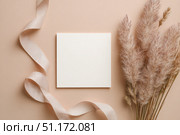 Blank greeting card, invitation mockup. Dry grass, pampas plant on beige table background. Flat lay, top view. Copyspace. Paper cards, mock up. Modern Minimal business brand template. Soft shadow. A6. Стоковое AI-изображение, AI-художник Марина Демидюк / Фотобанк Лори